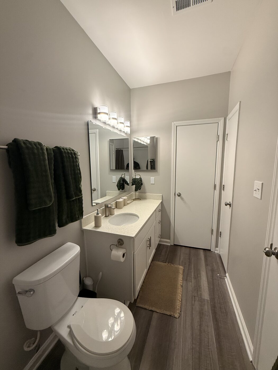 Bathroom hallway with vanity and closet doors