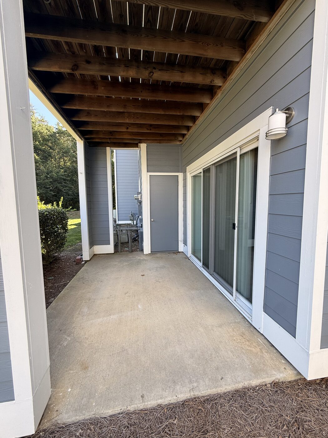Covered private patio with sliding door entry