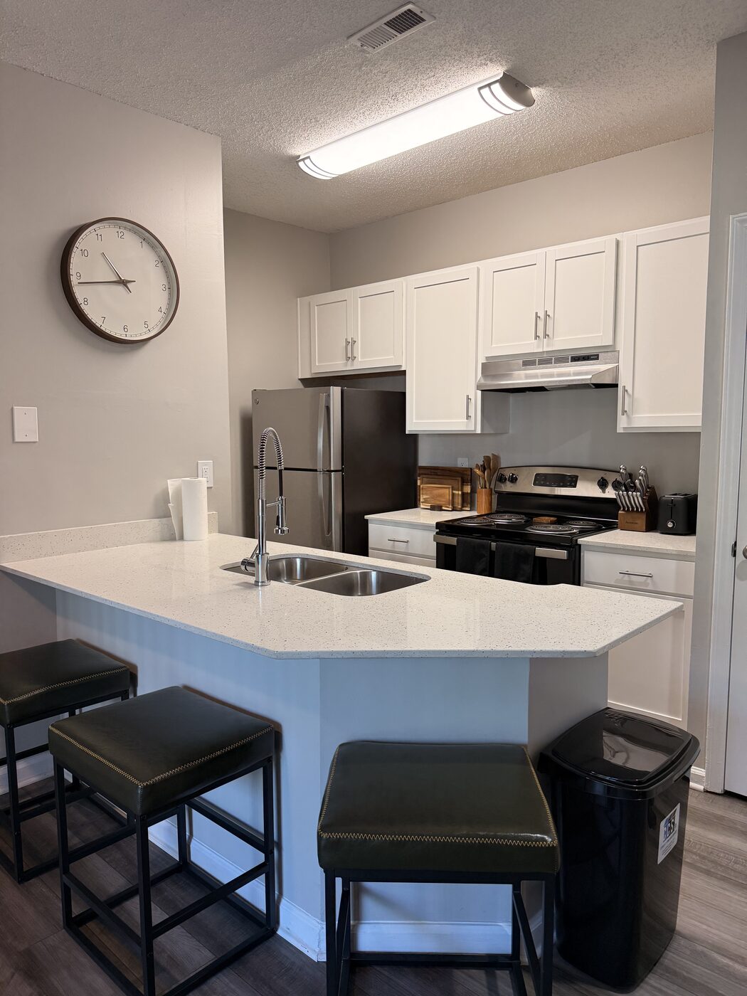 Kitchen island with sink and bar seating