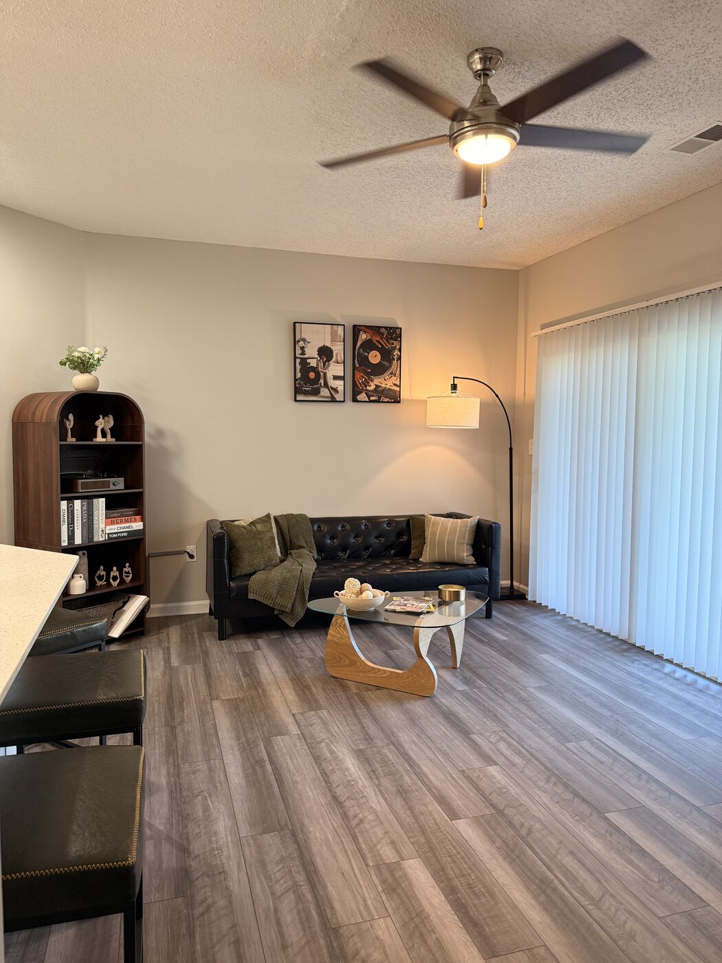 Living room with bookshelf, turntable, and leather sofa